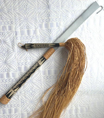 Traditional Samoan nifo oti (tooth of death) weapon featuring a curved wooden handle with sharp shark teeth meticulously bound along the edge using fine sennit cord, symbolizing cultural strength and craftsmanship.